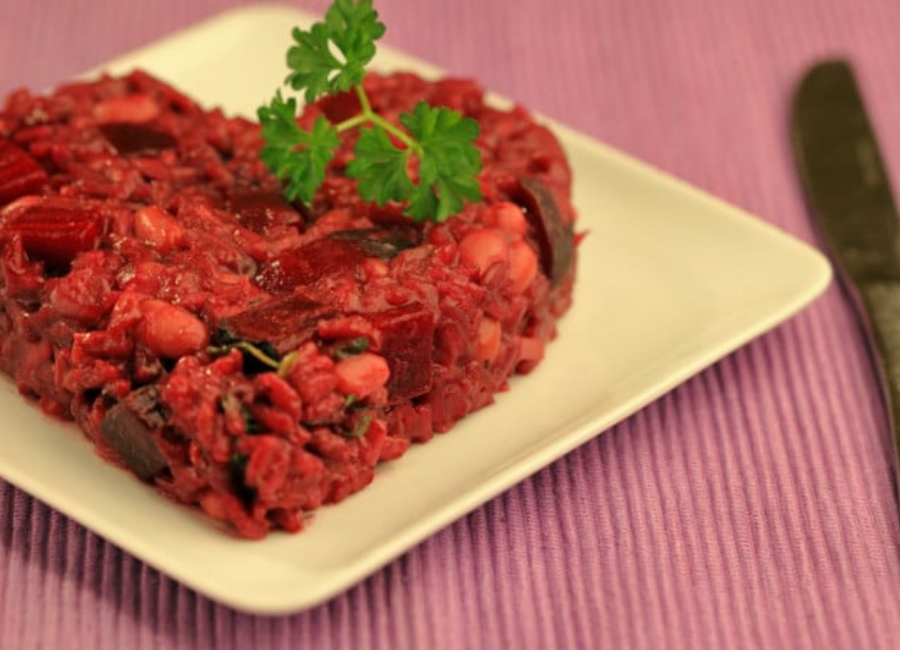 Pink beetroot risotto shaped like a heart.